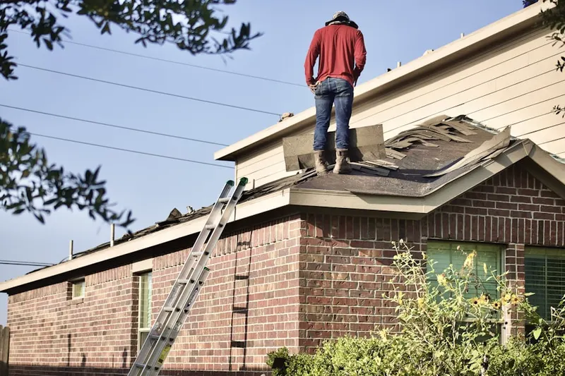 Professional roofer working on a residential roof in Pelican Bay